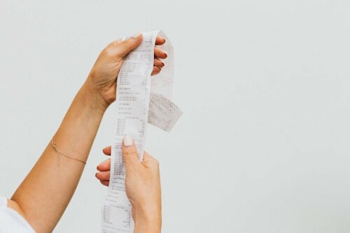 Thermal receipt paper in hands 768x512
